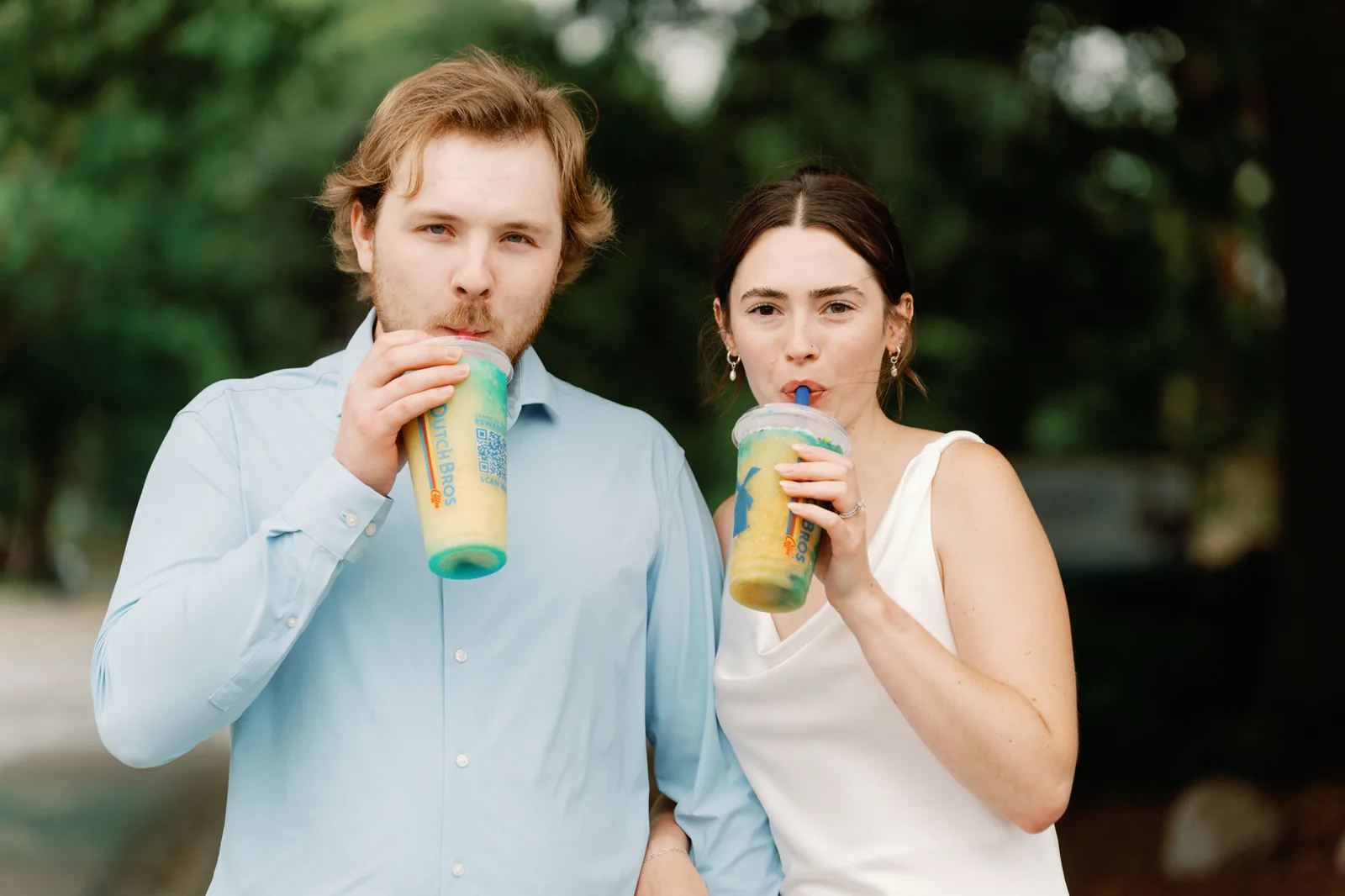 Abby and Jake sipping iced drinks together