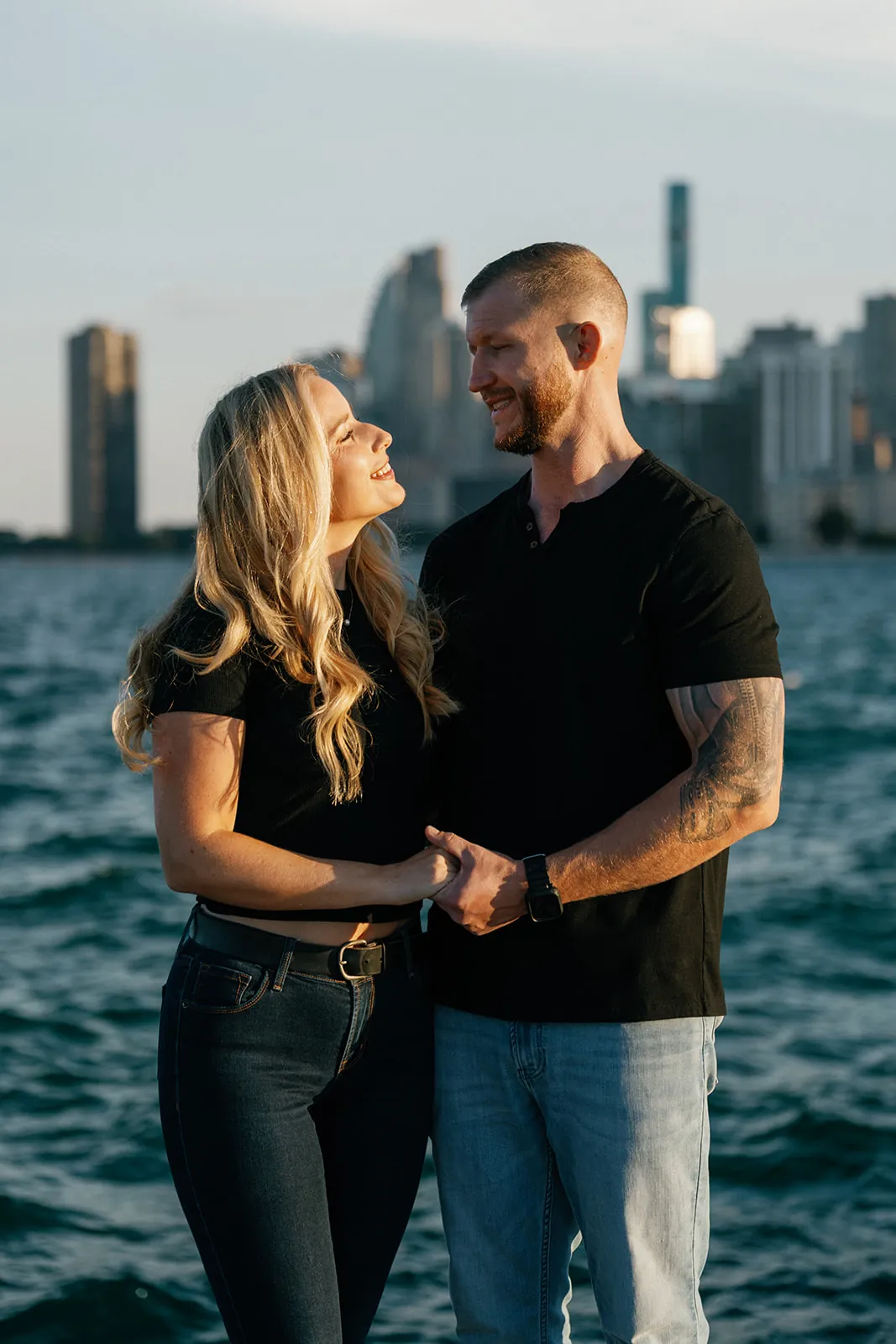 Kara and Chad by the lake with the Chicago skyline behind them